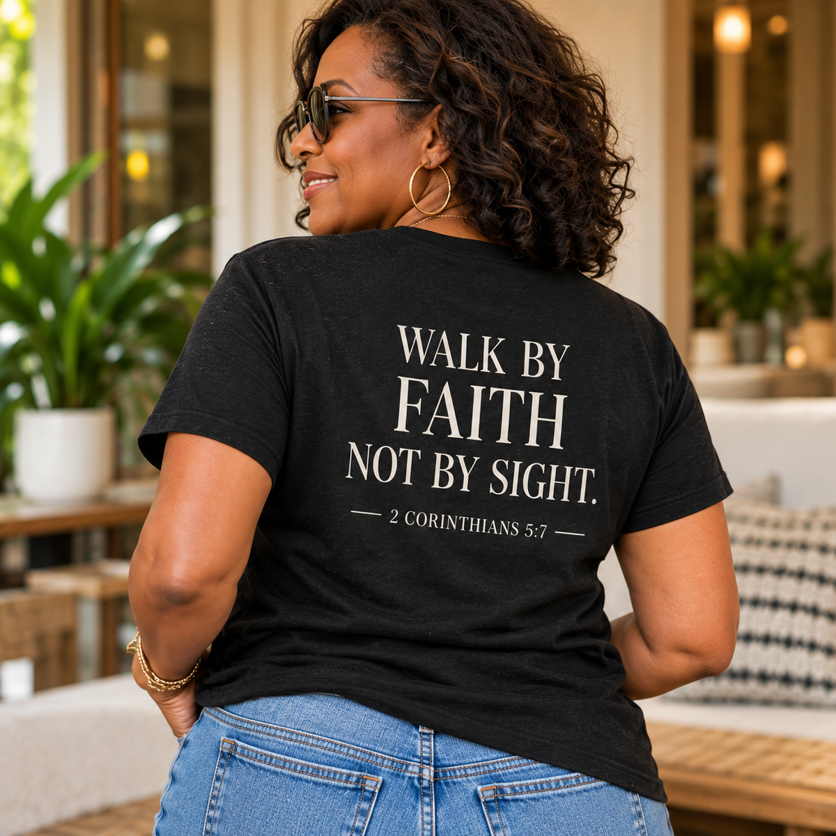 Woman wearing black Faith. Flow. Purpose. tee showing 2 Corinthians 5:7 back design
